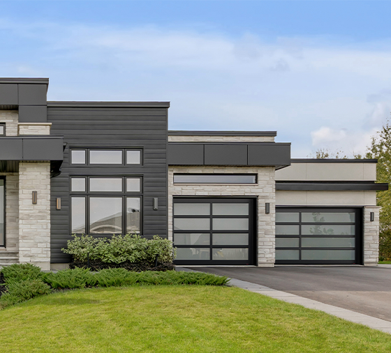 Garaga residential garage door with the Center & Offset all-glass design, Black frame and White Sandblasted glass.
