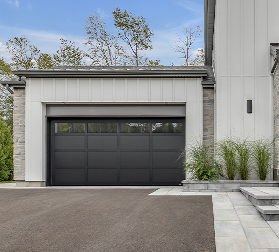 Garaga residential garage door in Black with the CL design, matching overlays and Panoramic windows.