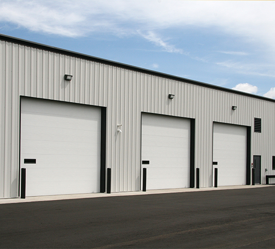 Garaga 16' x 14' commercial garage door in White with the Flush design, one window and Uniform woodgrain steel.