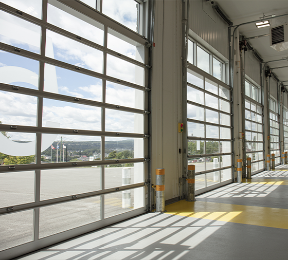 Garaga G-4400 commercial garage doors, 13-1/2' x 14' all-glass, Anodized frame and Clear glass.