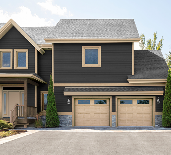 Garaga residential garage door with a Natural Oak HD faux-wood finish, the I1 design, a recessed base and windows.