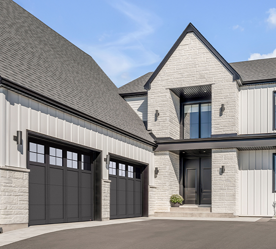 Garaga residential garage door in Black with the P-31 design, matching overlays and Panoramic windows.