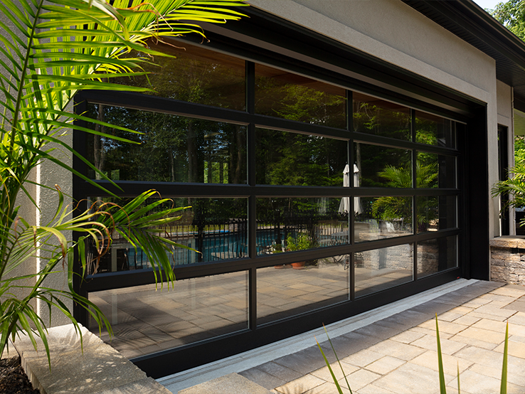 Garaga residential garage door with the Grid all-glass design, Black frame and Mirror glass.
