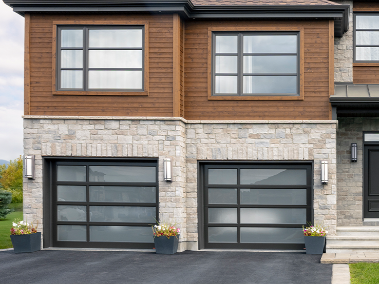 Garaga residential garage door with the Offset all-glass design, Black frame and White Sandblasted glass.