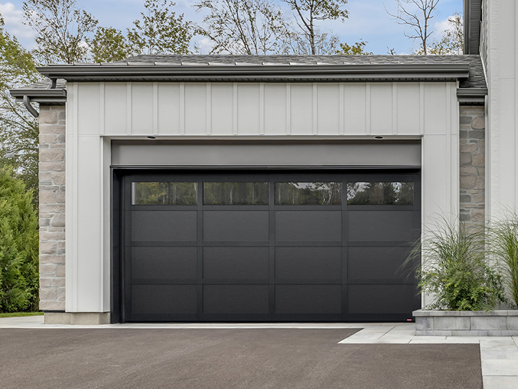 Garaga residential garage door in Black with the CL design, matching overlays and Panoramic windows.