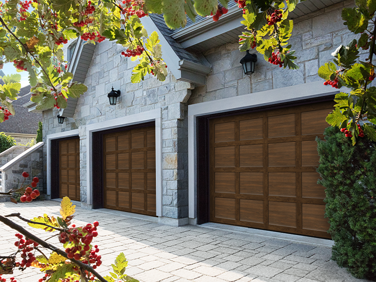 Garaga residential garage door with a Chocolate Walnut faux-wood finish, the CM design and matching overlays.