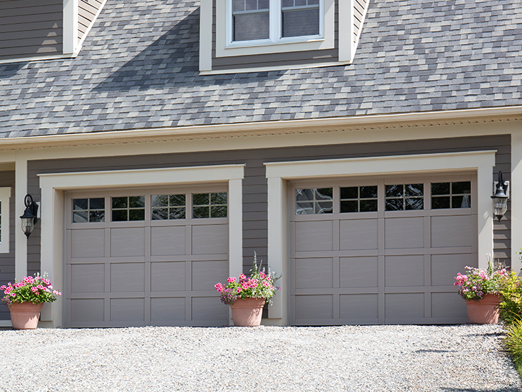 Garaga residential garage door in Claystone with the CM design, matching overlays and Panoramic windows.