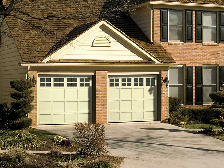 Garaga residential garage door in Desert Sand with the CM design, matching overlays and Panoramic windows.