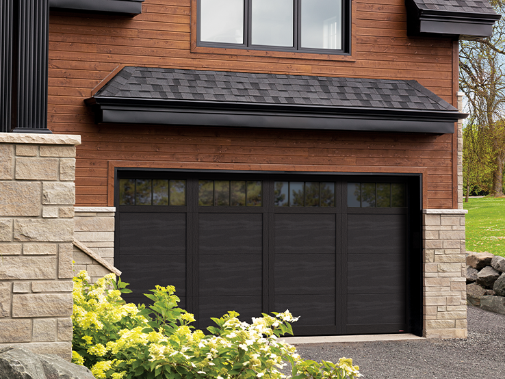 Garaga residential garage door in Black with the E-11 design, matching overlays and Panoramic windows.