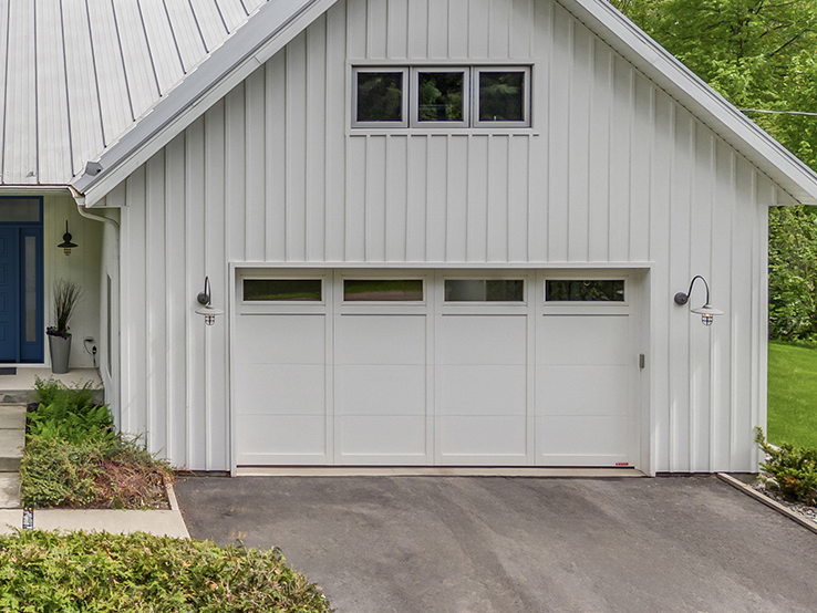 Garaga residential garage door in Ice White with the E-11 design, matching overlays and windows.