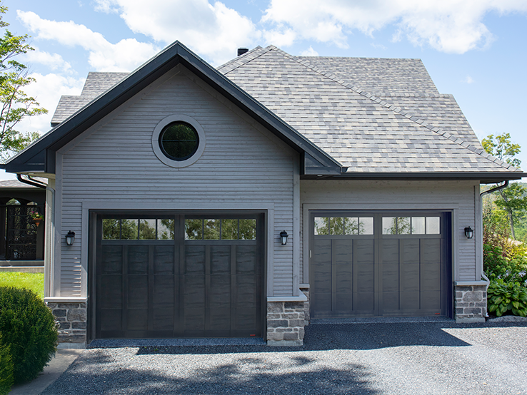 Garaga residential garage door in Black with the E-13 design, matching overlays and Panoramic windows.