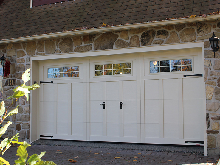 Garaga residential garage door in Desert Sand with the E-13 design, matching overlays and Orion windows.