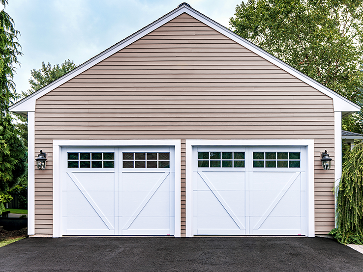 Garaga residential garage door in Ice White with the E-23 design, matching overlays and Panoramic windows.