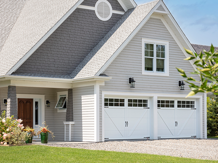 Garaga residential garage door in Ice White with the E-23 design, matching overlays and Panoramic windows.
