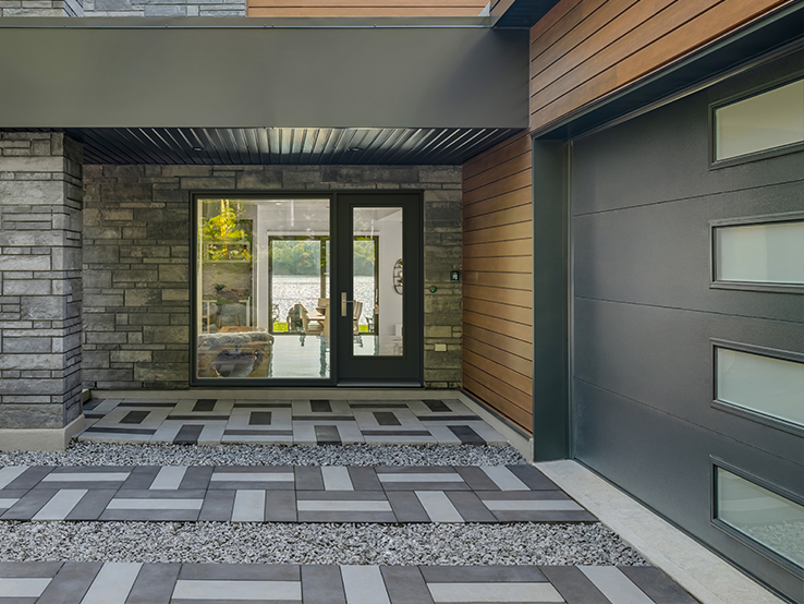 Garaga residential garage door in Black with the Flush design and Harmony windows.