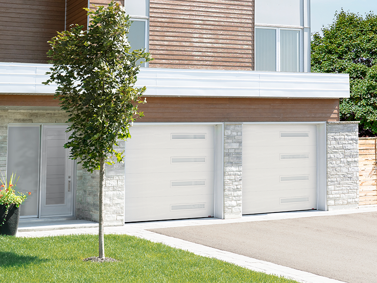Garaga residential garage door in Ice White with the Flush design and Harmony Slim windows.