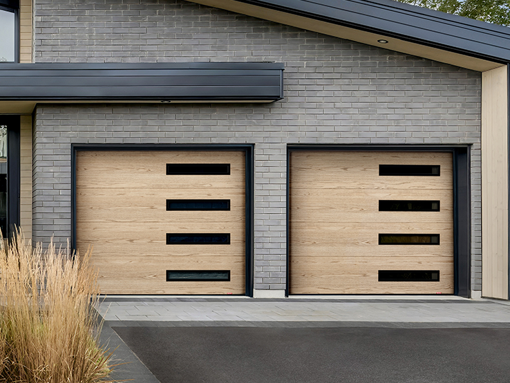 Garaga residential garage door with a Natural Oak HD faux-wood finish, the Flush design and Harmony Slim windows.