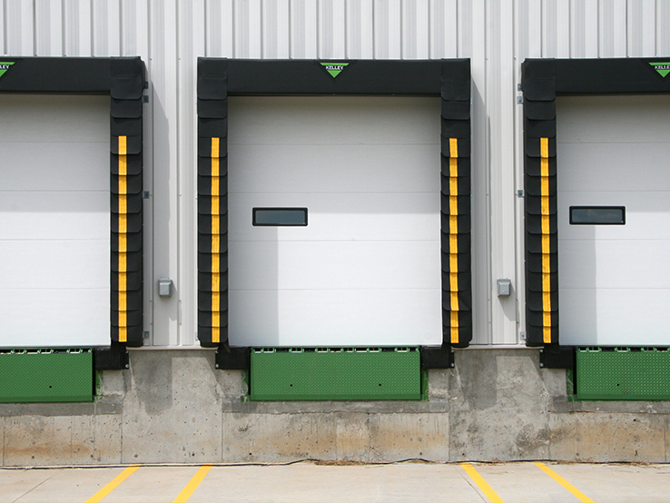 Garaga 8-1/2' x 9' commercial garage door in White with the Flush design, one window and Uniform woodgrain steel.