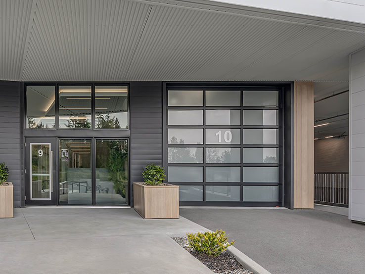 Garaga G-4400 commercial garage door, 12' x 12' all-glass, Black frame and White Sandblasted glass.