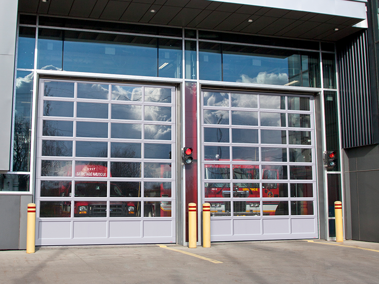 Garaga G-4400 commercial garage doors, 14' x 16' all-glass, Anodized kick-proof panel, Anodized frame and Clear glass.