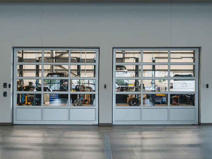 Garaga G-4400 commercial garage doors, 11' x 10' all-glass, Anodized kick-proof panel, Anodized frame and Clear glass.