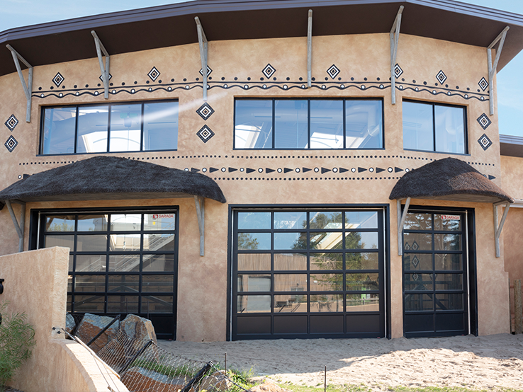 Garaga G-4400 commercial garage doors, 13' x 12' & 7' x 12' all-glass, Black kick-proof panel, Black frame and Clear glass.