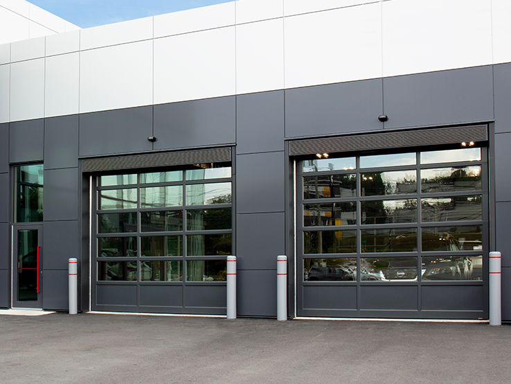 Garaga G-4400 commercial garage doors, 12' x 12' all-glass, Iron Ore kick-proof panel, Iron Ore frame and Clear glass.