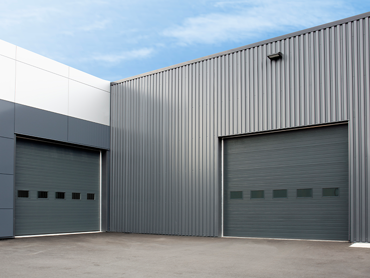 Garaga G-5000 commercial garage doors in Iron Ore, 14' x 12', Grooved design, windows and Uniform woodgrain steel.