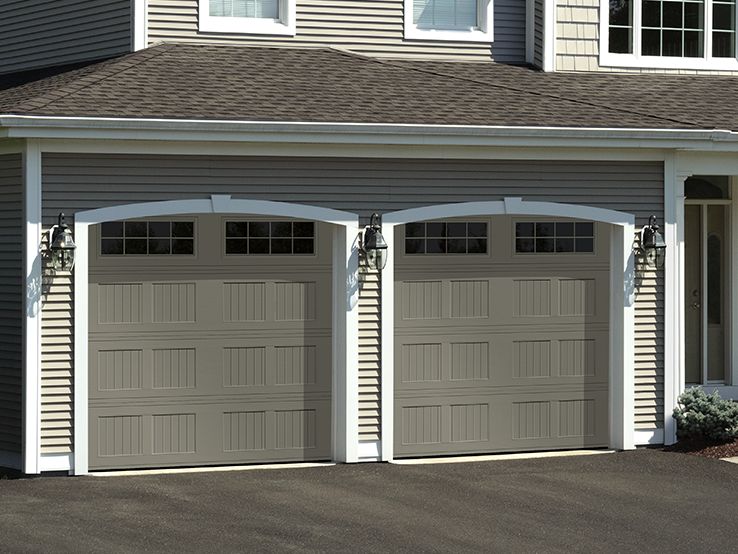 Garaga residential garage door in Terrastone with the I-1 design, a beadboard base and Stockton window inserts.