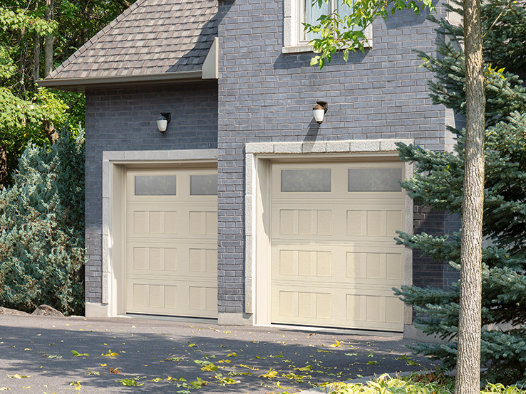 Garaga residential garage door in Almond with the I2 design, a recessed base and Satin windows.