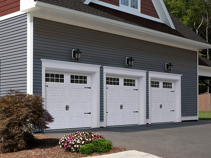 Garaga residential garage door in White with the X design, a four-slat louver base and Stockton window inserts.