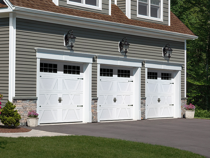 Garaga residential garage door in White with the X design, a recessed base and Stockton window inserts.