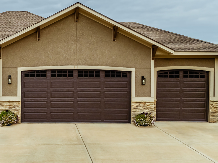 Garaga residential garage door in Brown with the Long Panel design and Stockton and Double Stockton Arch window inserts.