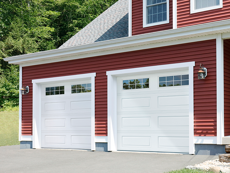 Garaga residential garage door in White with the Long Panel design and Stockton Long window inserts.