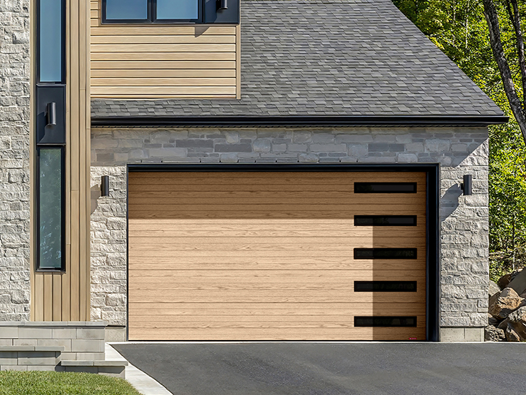 Garaga residential garage door with a Natural Oak HD wood-tone finish, the Moderno Multi design and Harmony Slim windows.