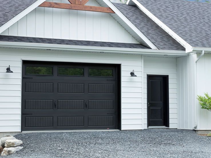 Garaga residential garage door in Black with the North Hatley LP design and Clear glass.