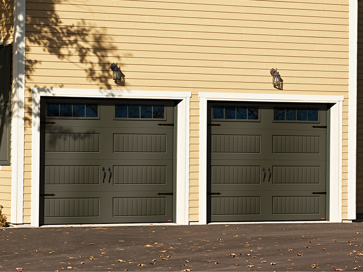 Garaga residential garage door in Dark Sand with the North Hatley LP design and Richmond Long window inserts.