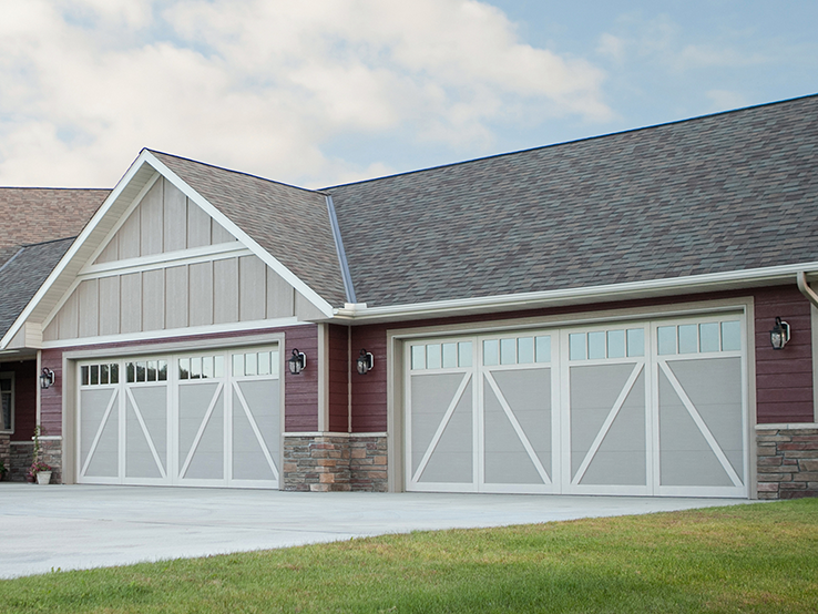 Garaga residential garage door in Beige with the A design, White overlays and Richmond Arch windows.