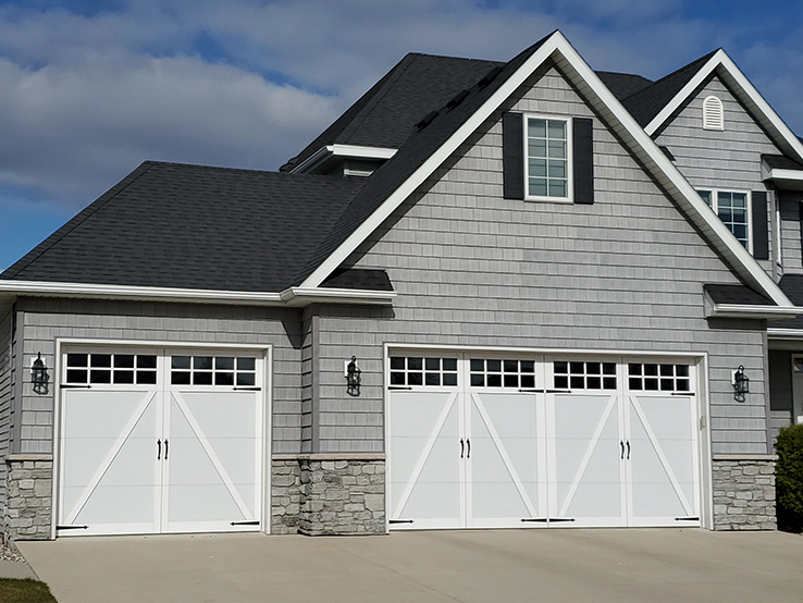 Garaga residential garage door in White with the A design, matching overlays and Stockton windows.