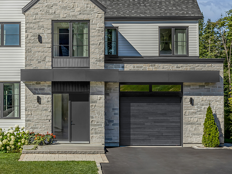 Garaga residential garage door with a Carbon Oak HD faux-wood finish and the Plank design.