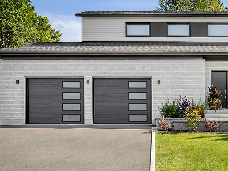 Garaga residential garage door with a Carbon Oak HD faux-wood finish, the Plank design and Right-side Harmony windows.