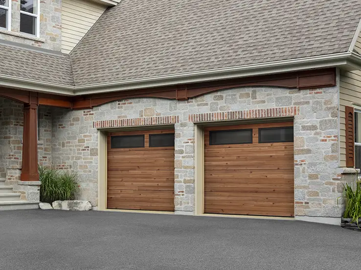 Garaga residential garage door with a Cedar HD faux-wood finish, the Plank design and Long windows with Tinted glass.
