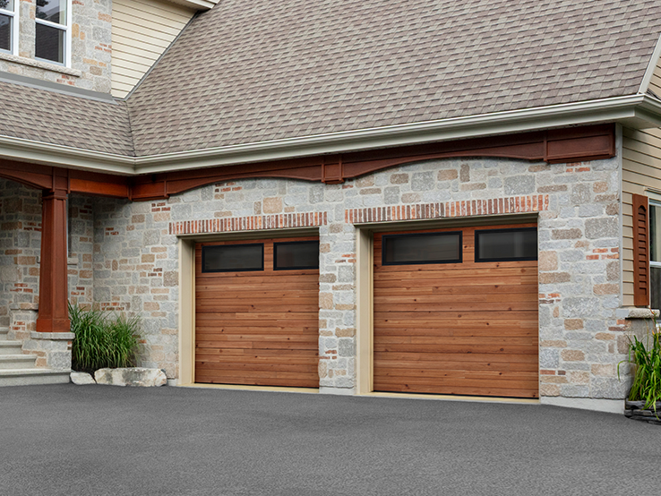 Garaga residential garage door with a Cedar HD faux-wood finish, the Plank design and Long windows with Tinted glass.