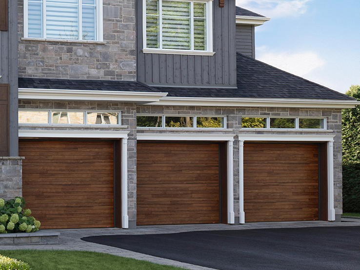 Garaga residential garage door with a Dark Acacia HD faux-wood finish, the Plank design and Long windows with Tinted glass.