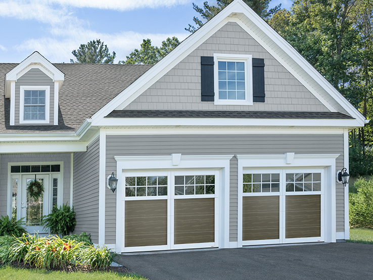 Garaga residential garage door in Dark Sand with the P-11 design, Ice White overlays and Panoramic windows.