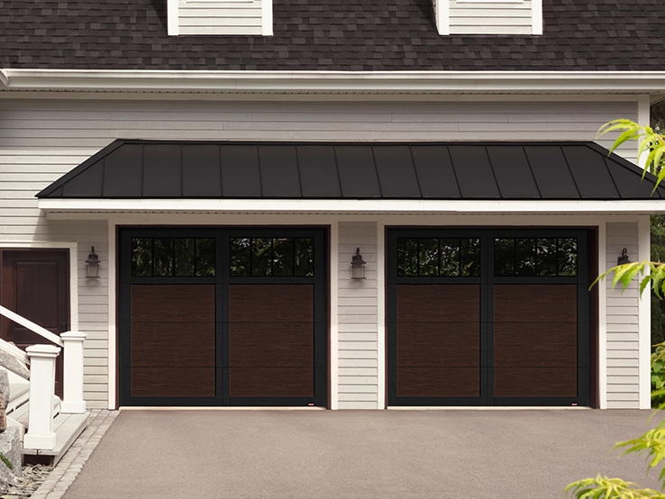 Garaga residential garage door with a Dark Walnut faux-wood finish, the P-11 design, Black overlays and Panoramic windows.