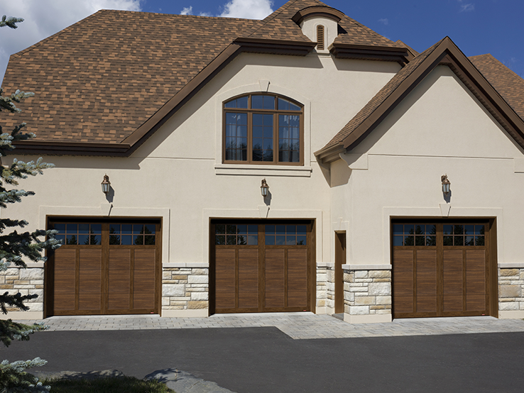 Garaga residential garage door with a Chocolate Walnut faux-wood finish, the P-12 design, matching overlays and Panoramic windows.