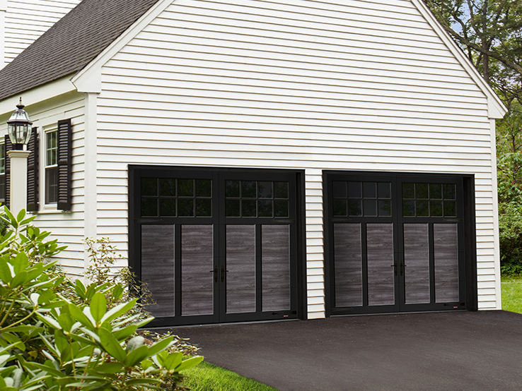Garaga residential garage door with a Weathered Grey faux-wood finish, the P-12 design, Black overlays and Panoramic windows.