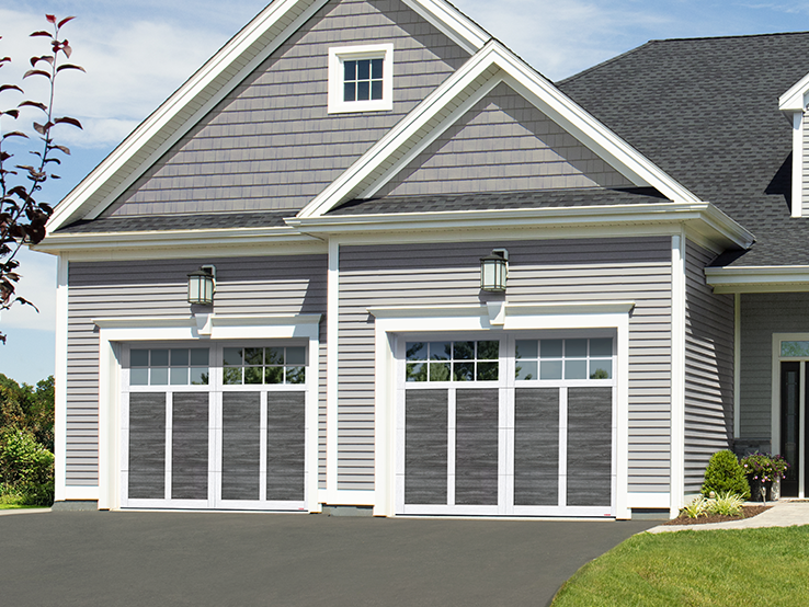 Garaga residential garage door with a Weathered Grey faux-wood finish, the P-12 design and Ice White overlays.