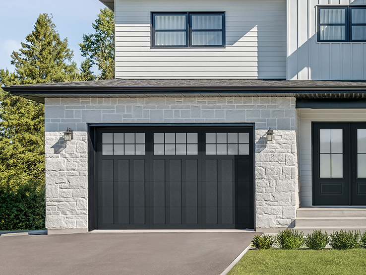 Garaga residential garage door in Black with the P-13 design, matching overlays and Panoramic windows.